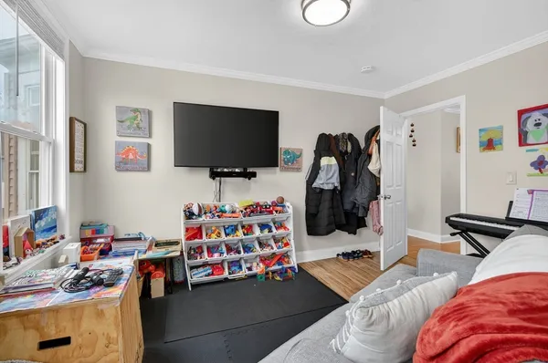 a bedroom with furniture and a flat screen tv