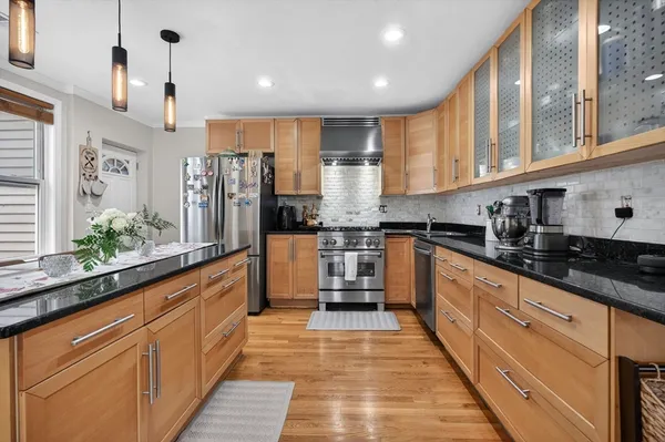 a kitchen with granite countertop a refrigerator and a sink