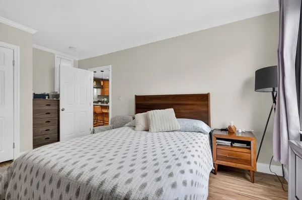 a bedroom with a bed and a view of closet