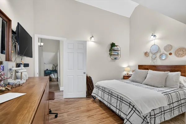a bedroom with a bed and a flat screen tv