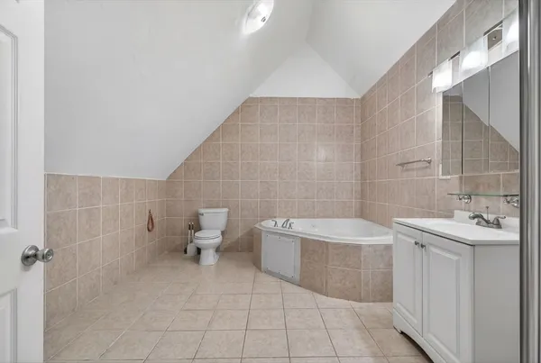 a bathroom with a sink mirror and toilet