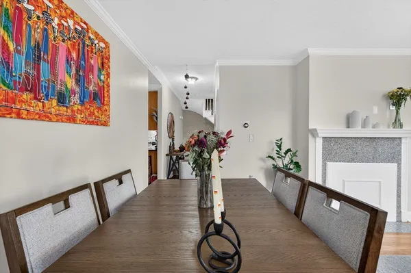 a view of a hallway with furniture and chandelier