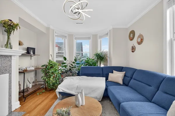 a living room with furniture and a chandelier