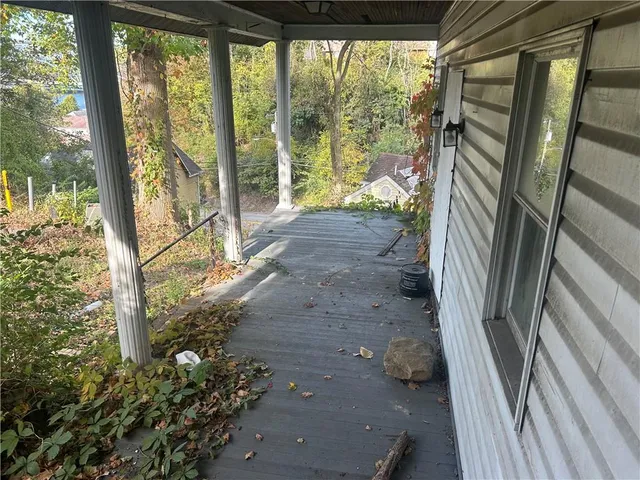 a view of a porch with wooden floor and outdoor space
