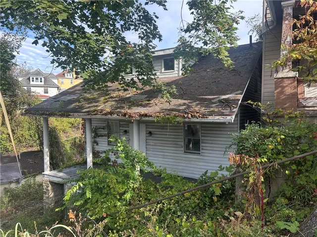 front view of a house with a tree in front of it