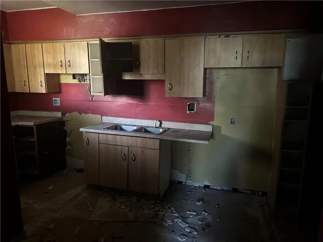 a kitchen with stainless steel appliances a sink stove and refrigerator