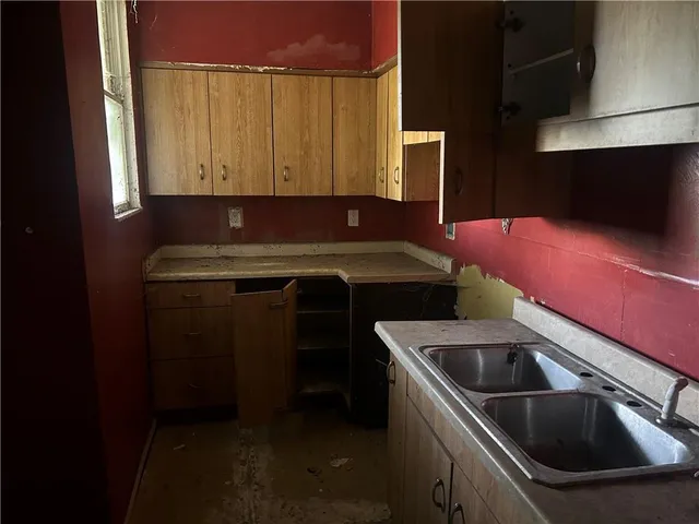 a kitchen that has a sink and a stove