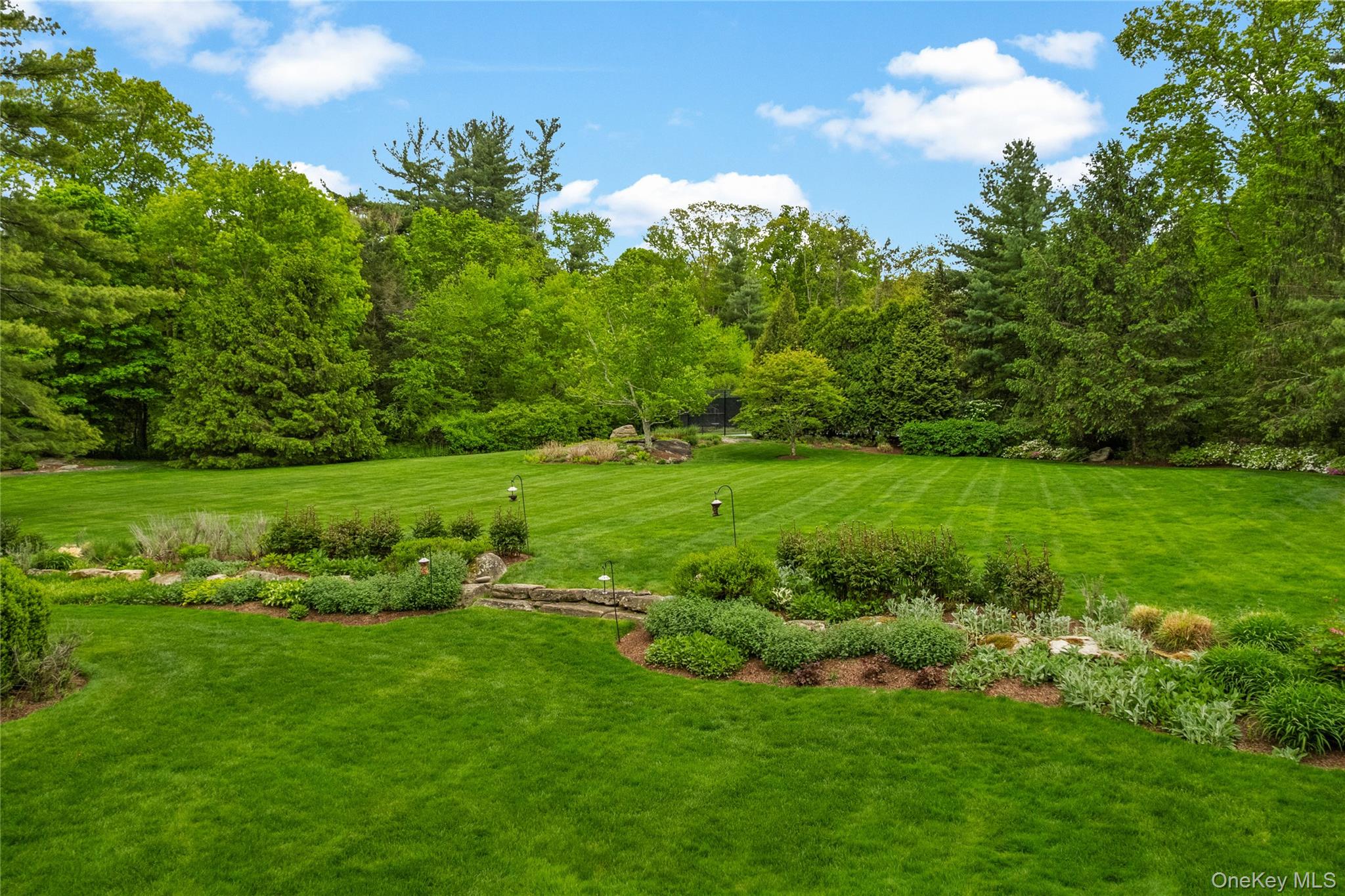 63 Old Mill River Road Pound Ridge, NY 10576 - Photo 42 of 47 a view of a lush green space
