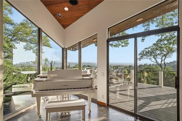 a living room with furniture and large windows