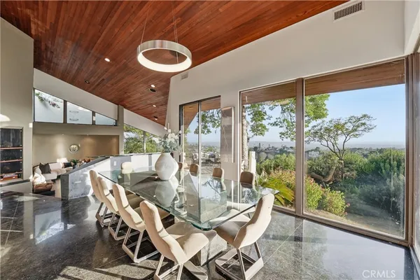 a dining room with furniture a chandelier and wooden floor