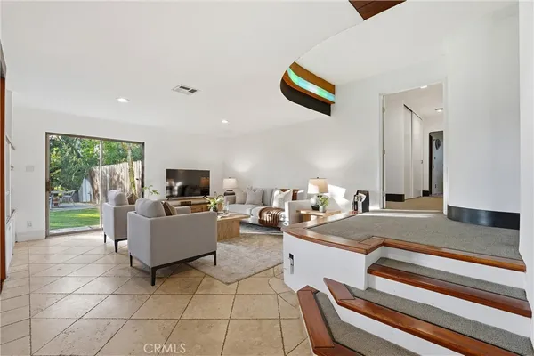 a living room with fireplace furniture and a flat screen tv