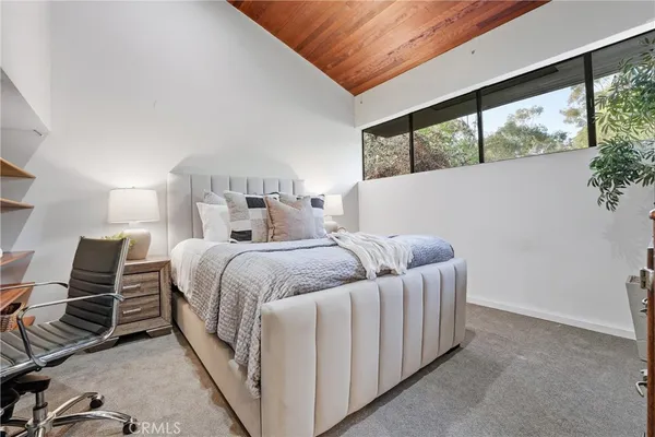 a living room with furniture and a book shelf