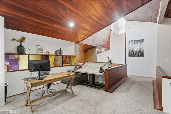 a view of a balcony with chair and wooden floor