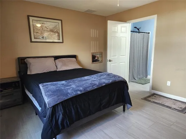 a bedroom with a bed and a dresser