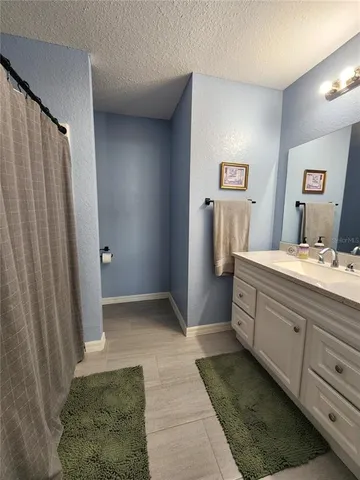 a bathroom with a double vanity sink and mirror