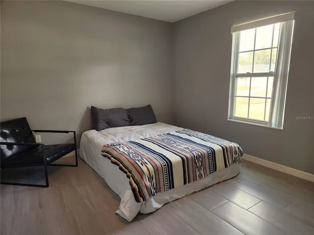 a bedroom with a bed and window