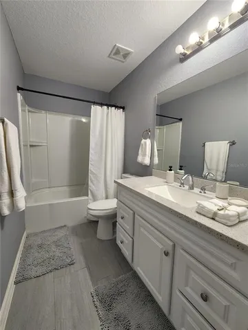 a front view of house with yard and trees