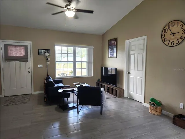 a view of a livingroom with workspace and a window