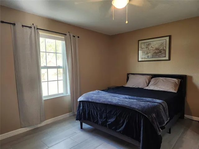 a bedroom with a bed and a window