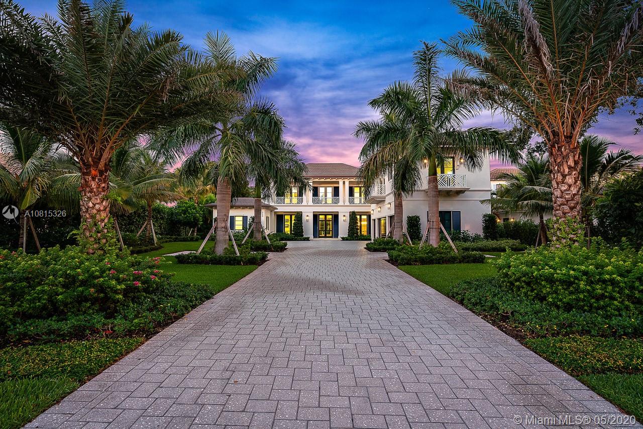 220 Commodore Drive Jupiter, FL 33477 - Photo 1 of 55 a view of multiple houses with a yard and palm trees