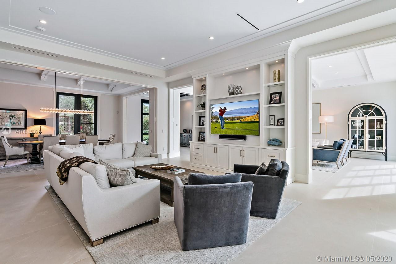 220 Commodore Drive Jupiter, FL 33477 - Photo 13 of 55 a living room with furniture flat screen tv and a fireplace