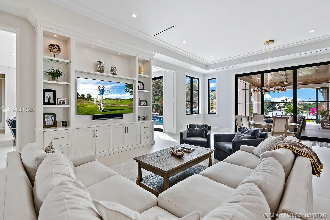 220 Commodore Drive Jupiter, FL 33477 - Photo 15 of 55 a living room with furniture flat screen tv and a large window
