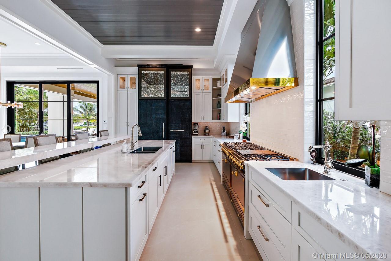 220 Commodore Drive Jupiter, FL 33477 - Photo 18 of 55 a kitchen with stainless steel appliances a sink stove and cabinets