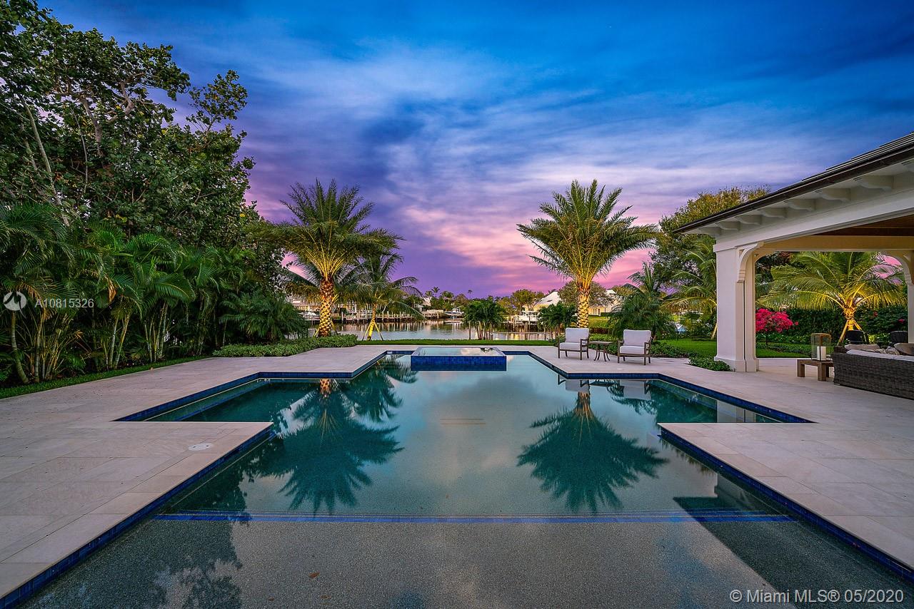 220 Commodore Drive Jupiter, FL 33477 - Photo 2 of 55 a view of swimming pool with outdoor seating and plants