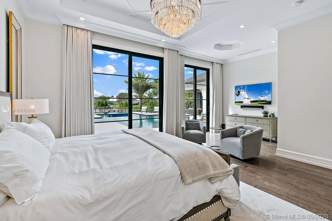 220 Commodore Drive Jupiter, FL 33477 - Photo 25 of 55 a bedroom with a bed and a large window