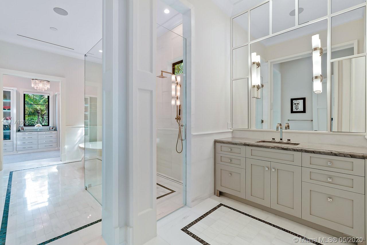 220 Commodore Drive Jupiter, FL 33477 - Photo 27 of 55 a spacious bathroom with a granite countertop sink mirror and shower