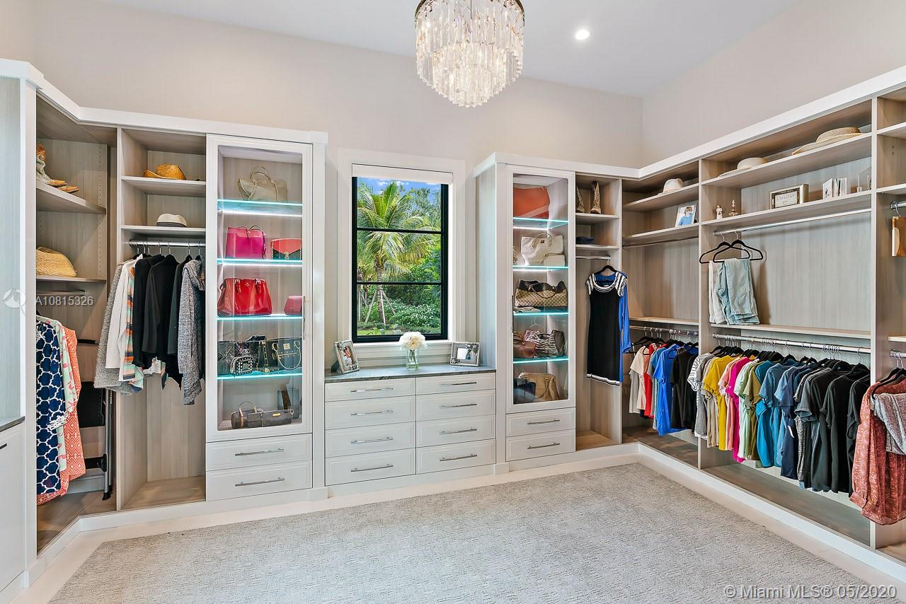 220 Commodore Drive Jupiter, FL 33477 - Photo 29 of 55 a view of walk in closet with clothes and shoes
