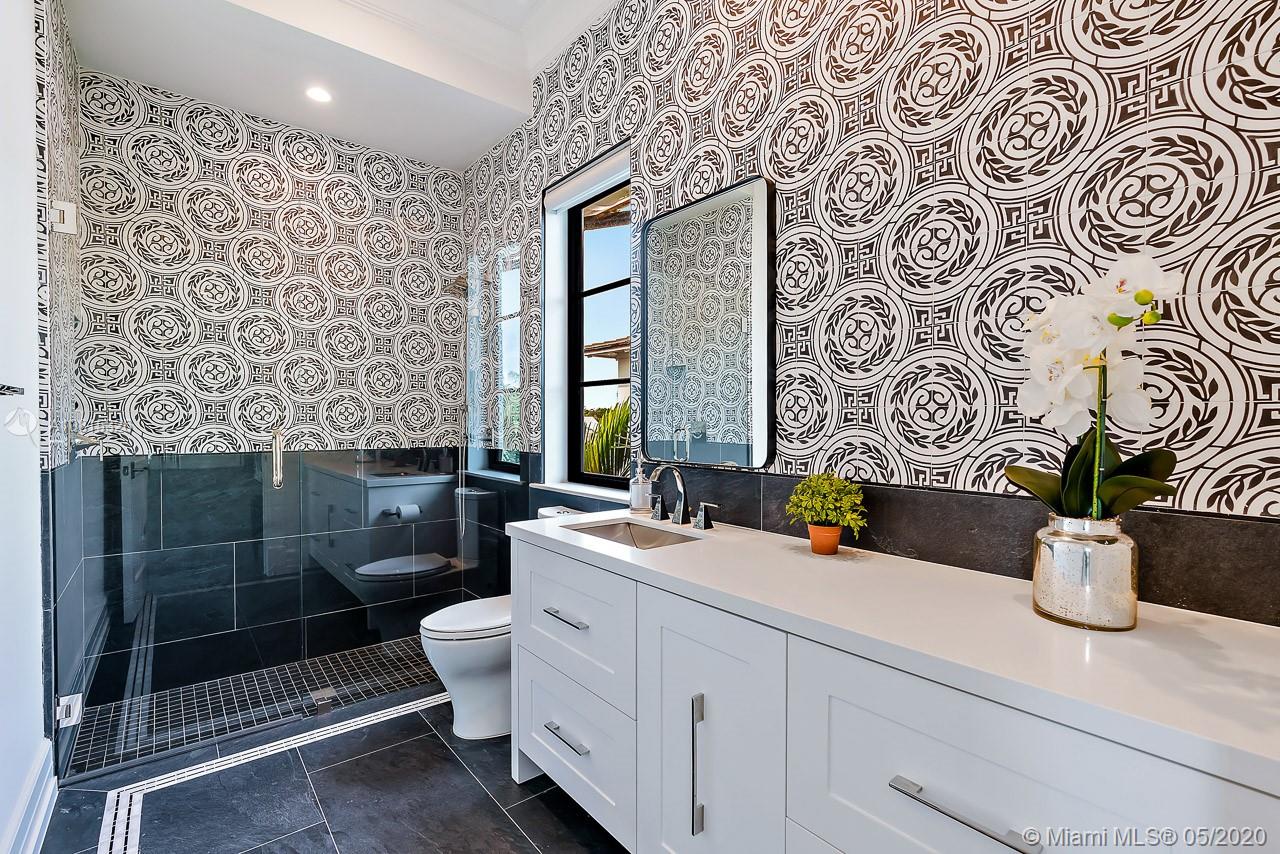 220 Commodore Drive Jupiter, FL 33477 - Photo 33 of 55 a bathroom with a toilet sink and mirror