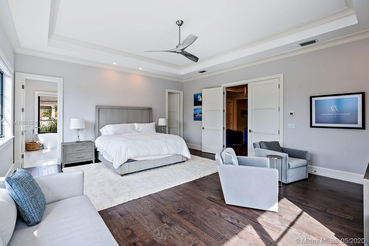 220 Commodore Drive Jupiter, FL 33477 - Photo 34 of 55 a bedroom with a large bed couch and a window