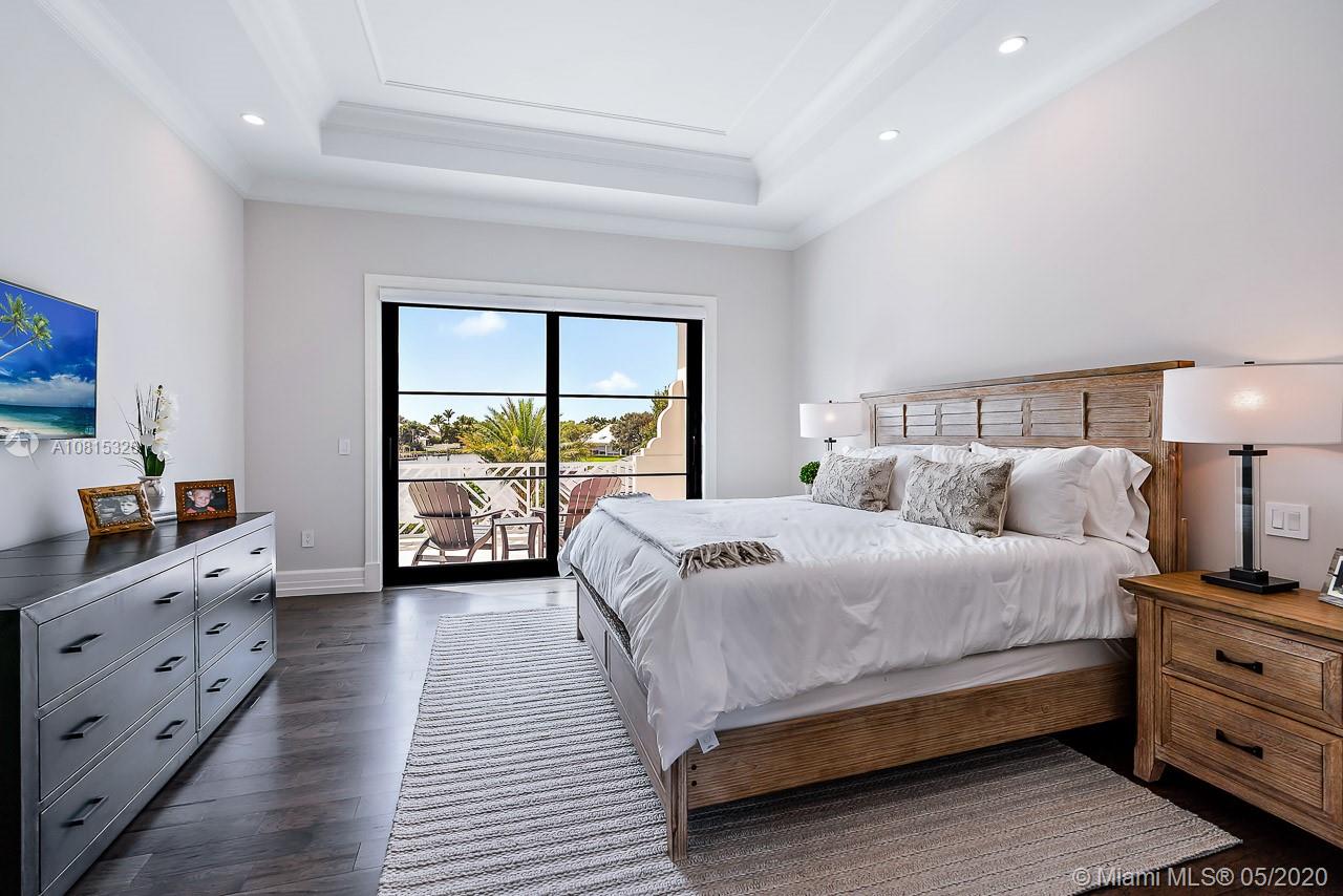 220 Commodore Drive Jupiter, FL 33477 - Photo 36 of 55 a bed room with a bed and a large window