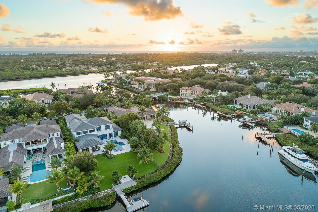 220 Commodore Drive Jupiter, FL 33477 - Photo 8 of 55 an aerial view of residential building with outdoor space and lake view