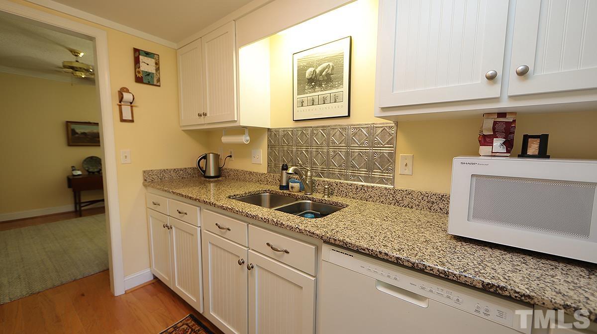 3137 Morningside Drive Raleigh, NC 27607 - Photo 5 of 15 a kitchen with sink cabinets and window