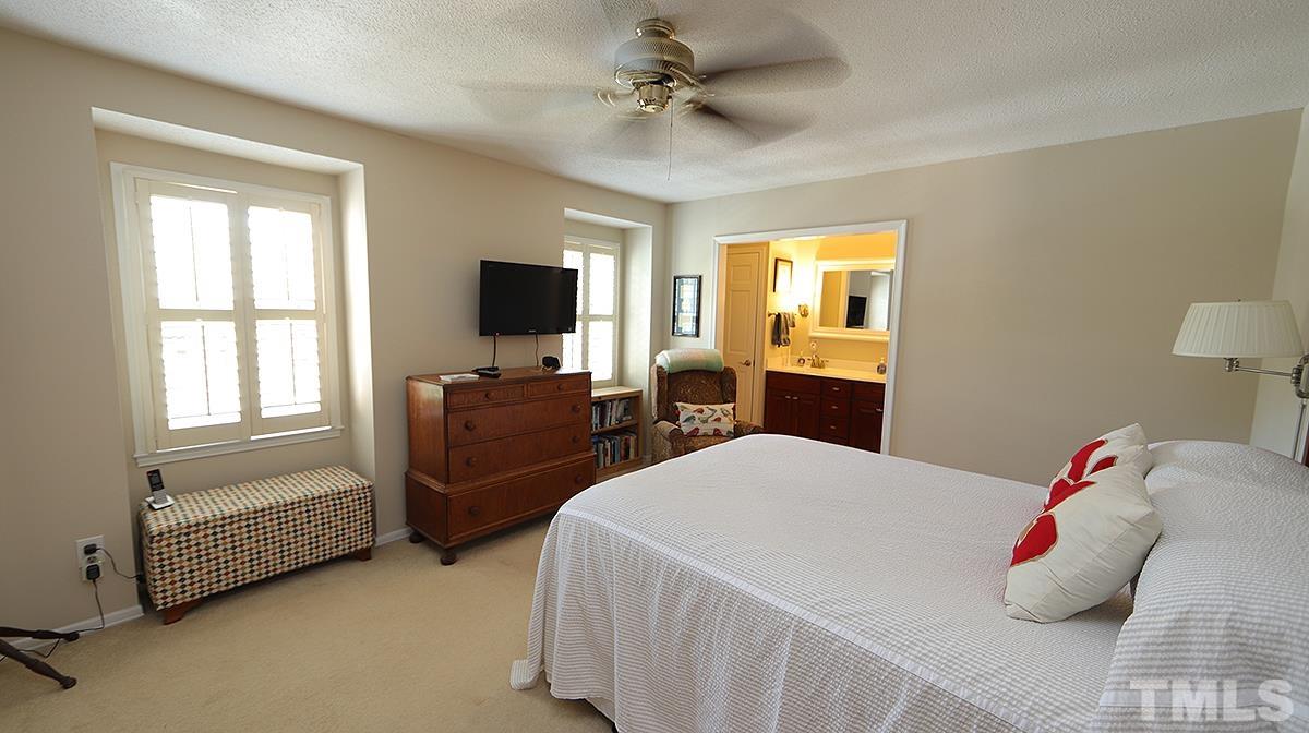 3137 Morningside Drive Raleigh, NC 27607 - Photo 8 of 15 a bedroom with a bed and a flat screen tv