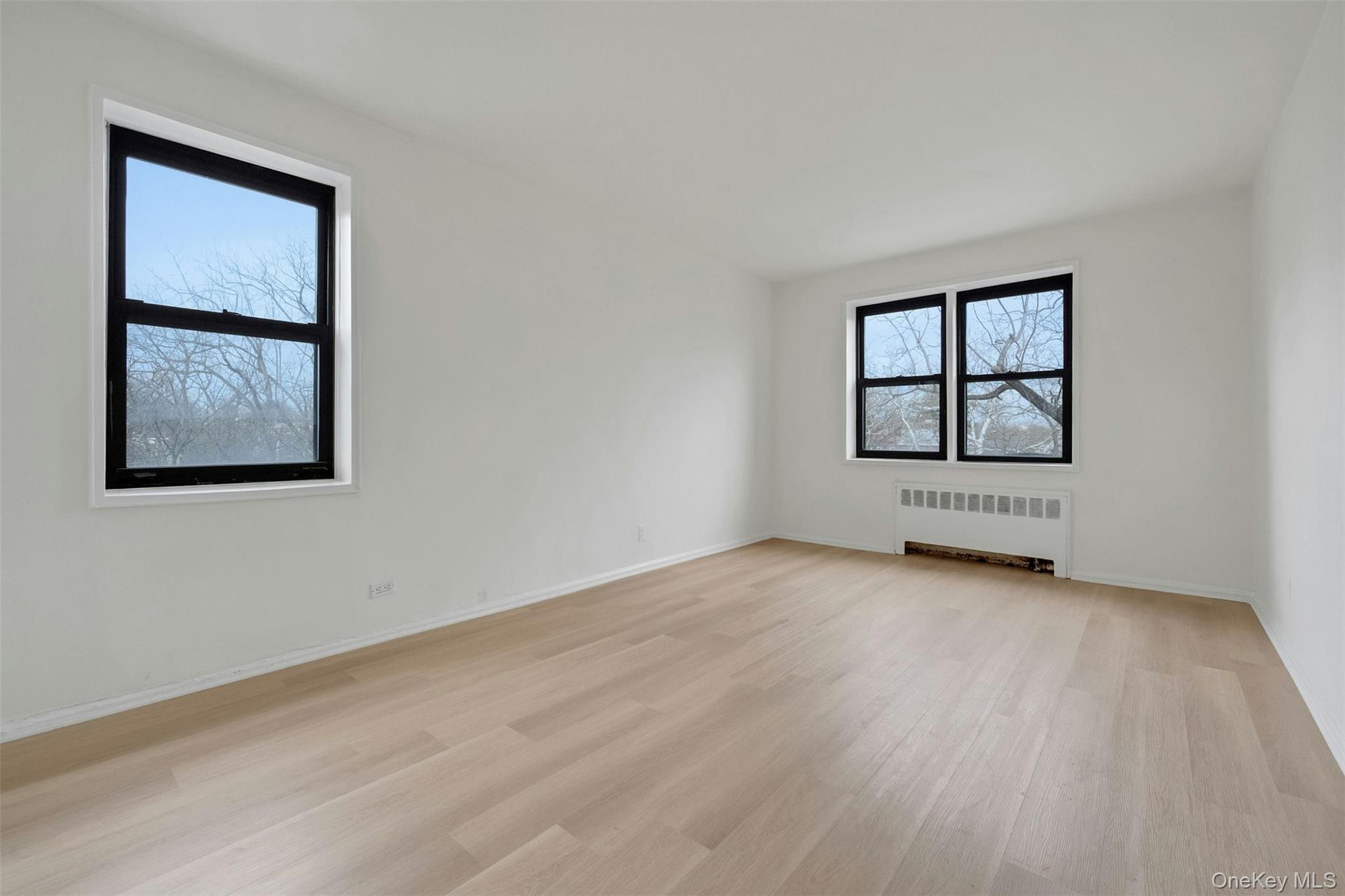 620 Pelham Road, Unit 6J New Rochelle, NY 10805 - Photo 11 of 26 an empty room with wooden floor and windows