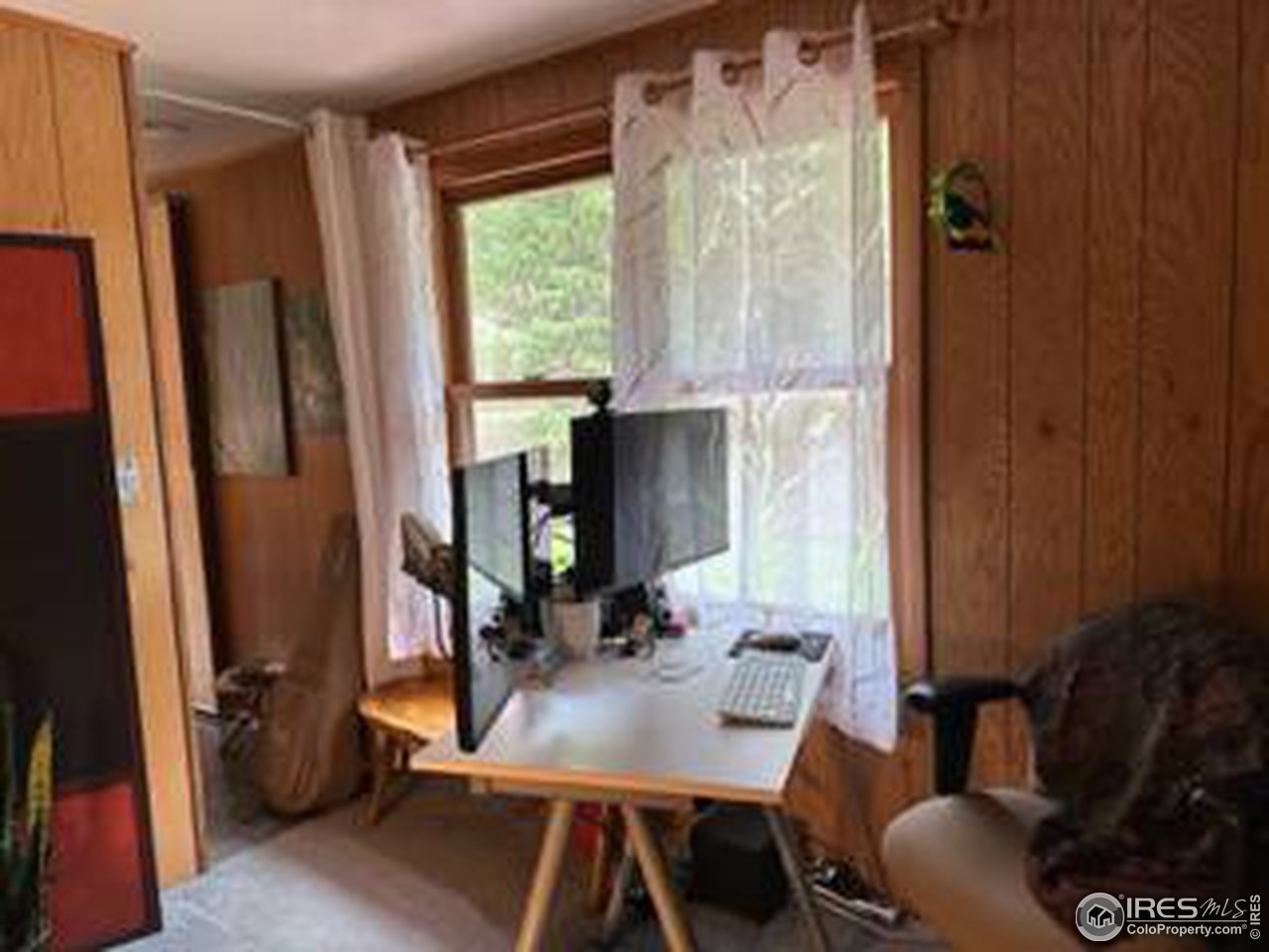 702 Riverside Drive Lyons, CO 80540 - Photo 11 of 19 a view of a workspace with furniture and a window