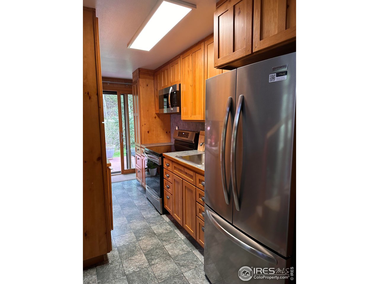 702 Riverside Drive Lyons, CO 80540 - Photo 5 of 19 a kitchen with stainless steel appliances granite countertop a refrigerator and a stove