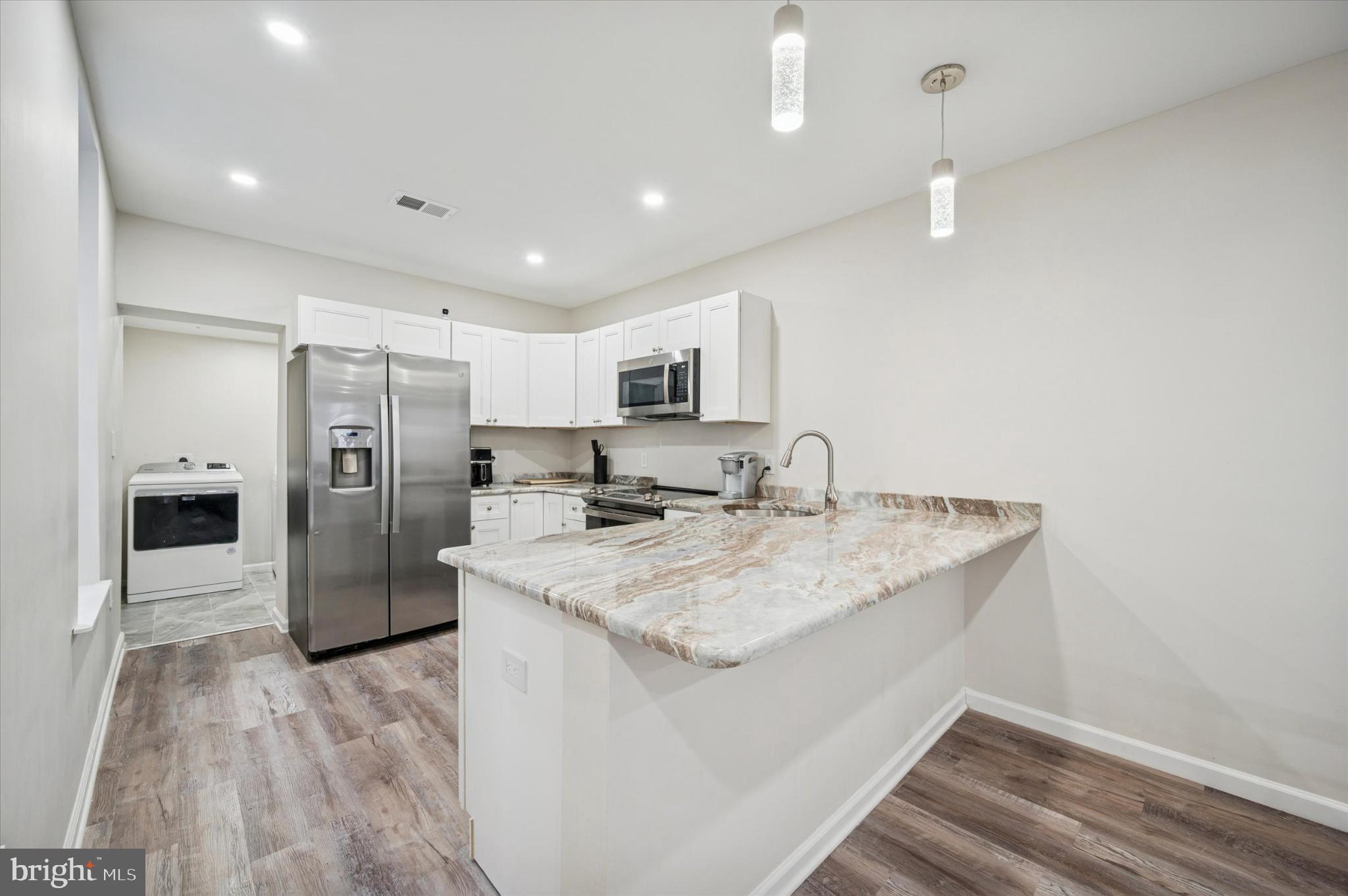 232 South Edgewood Street Philadelphia, PA 19139 - Photo 6 of 25 Modern kitchen with sleek finishes.
