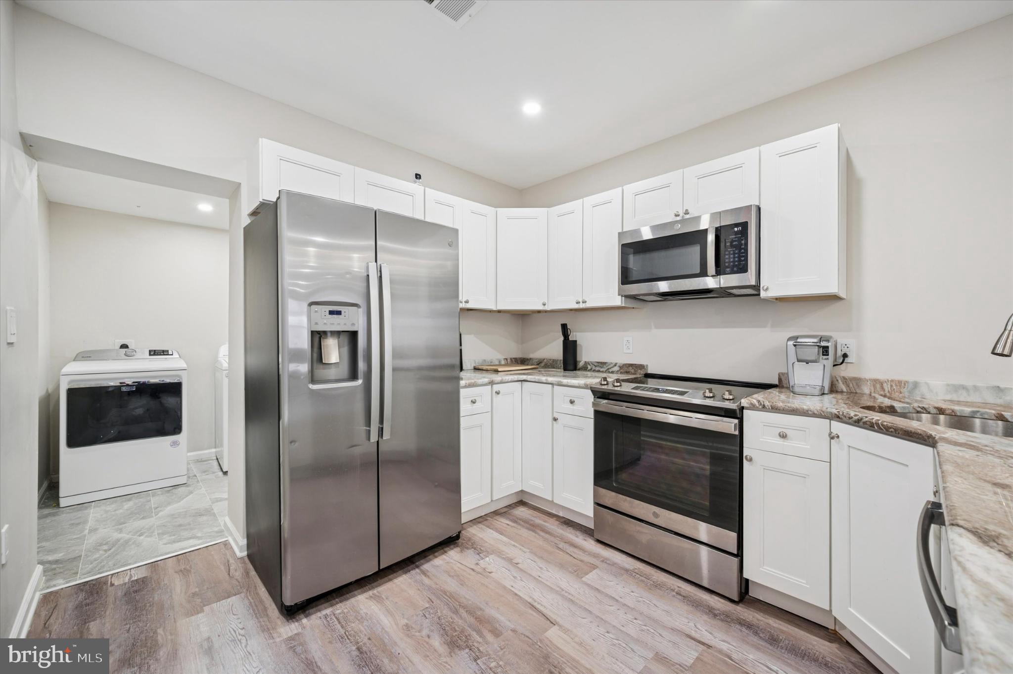232 South Edgewood Street Philadelphia, PA 19139 - Photo 7 of 25 Modern kitchen with sleek appliances.