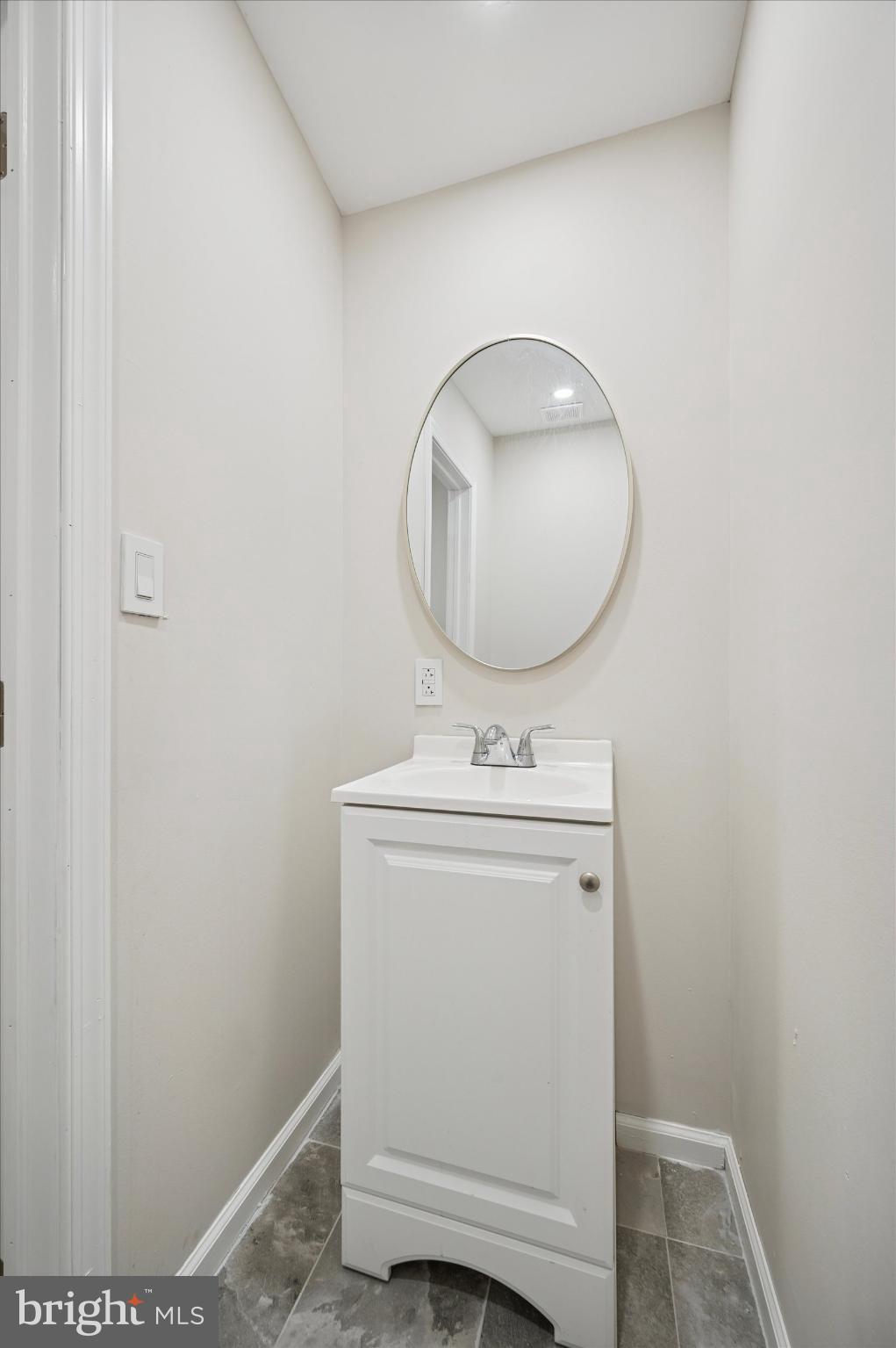 232 South Edgewood Street Philadelphia, PA 19139 - Photo 10 of 25 Sleek powder room with modern elegance.