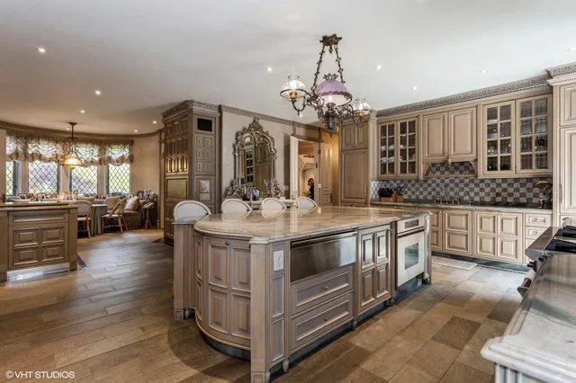a view of living room kitchen with stainless steel appliances granite countertop furniture and wooden floor