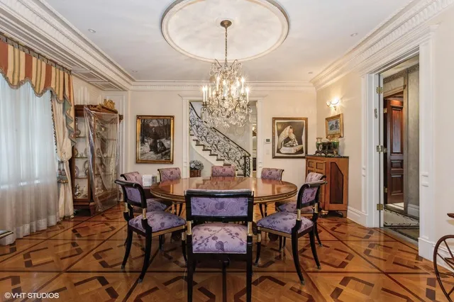 a view of a dining room with furniture and chandelier