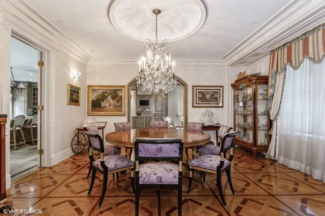 a view of a dining room with furniture and chandelier