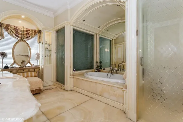 a en suite bathroom with a double vanity sink and a mirror
