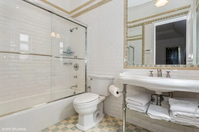 a bathroom with a sink toilet a mirror and shower