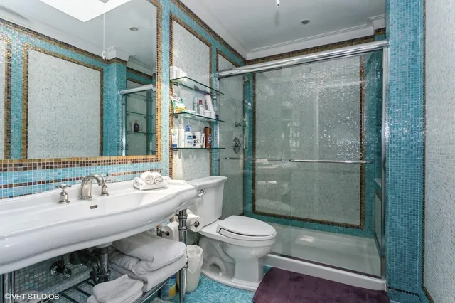 a bathroom with a sink toilet and shower