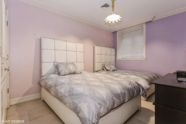a bedroom with a bed and a chandelier